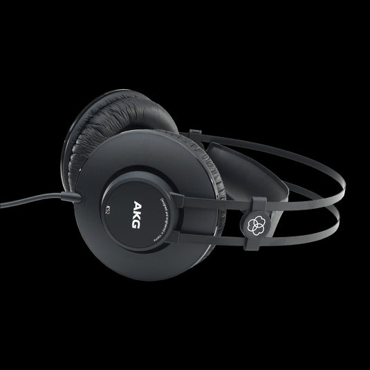 AKG K52 closed-back studio headphones resting on a surface, showcasing their design and features.