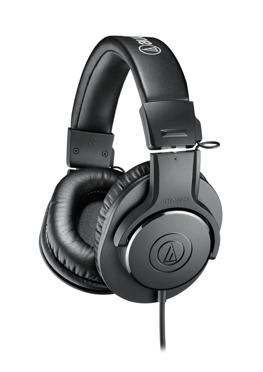 Audio-Technica ATH-M20X headphones on a studio table, highlighting their sleek design and superior build quality.