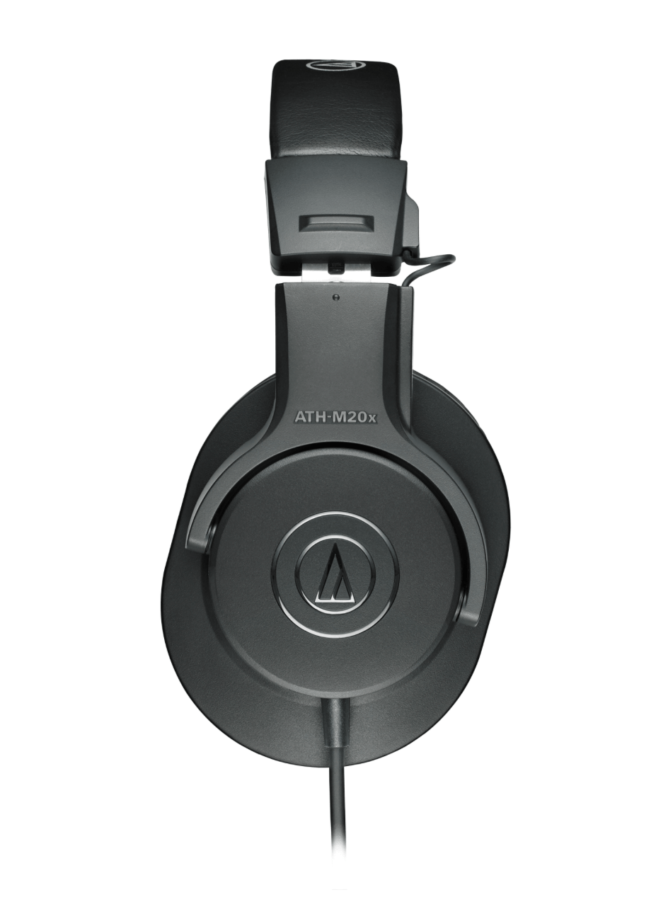 Audio-Technica ATH-M20X headphones on a studio table, highlighting their sleek design and superior build quality. Side