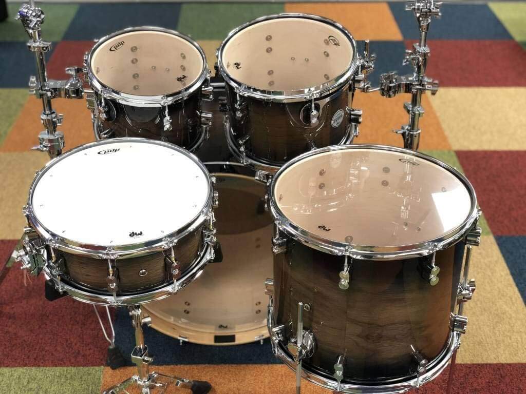 PDP Concept Exotic 5-Piece Shell Pack in Walnut and Charcoal Burst finish, showcasing the drum set's elegant design and craftsmanship.