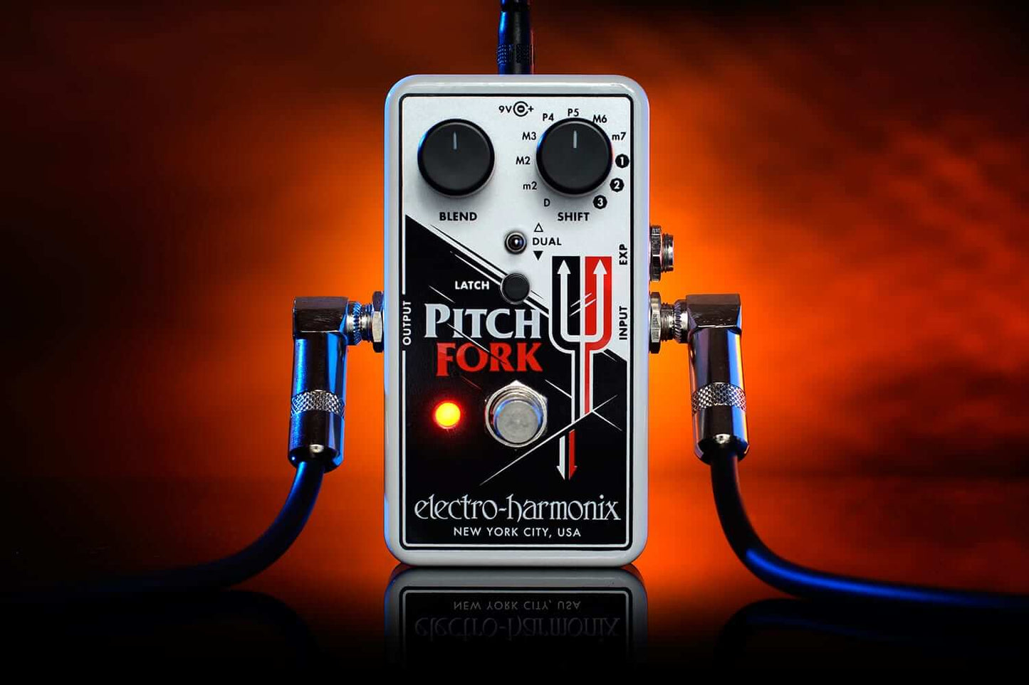 Electro-Harmonix Pitch Fork Polyphonic Pitch Shifting Guitar Pedal displayed on a wooden surface.