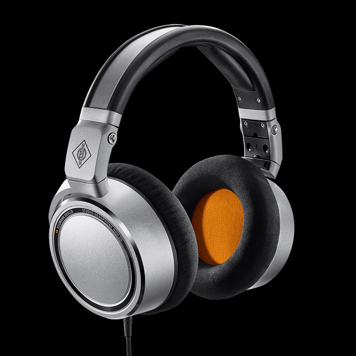 Neumann NDH 20 closed-back headphones in silver, featuring a circumaural design and foldable structure, with a 6.3/3.5mm adaptor.