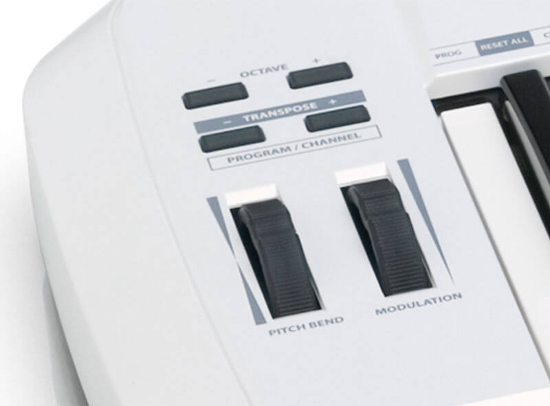 Samson Carbon 61, a 61-key USB MIDI keyboard controller featuring assignable controls and an iPad slot, shown with mod wheels.