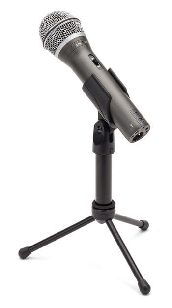 Samson Q2U handheld dynamic USB/XLR microphone displayed on a stand, showcasing its cardioid pattern and headphone output features.
