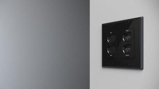 Xilica Neutrik XLR 2x2 to Dante In-Wall Module for EU/UK and US Electrical Boxes displayed on a wall.