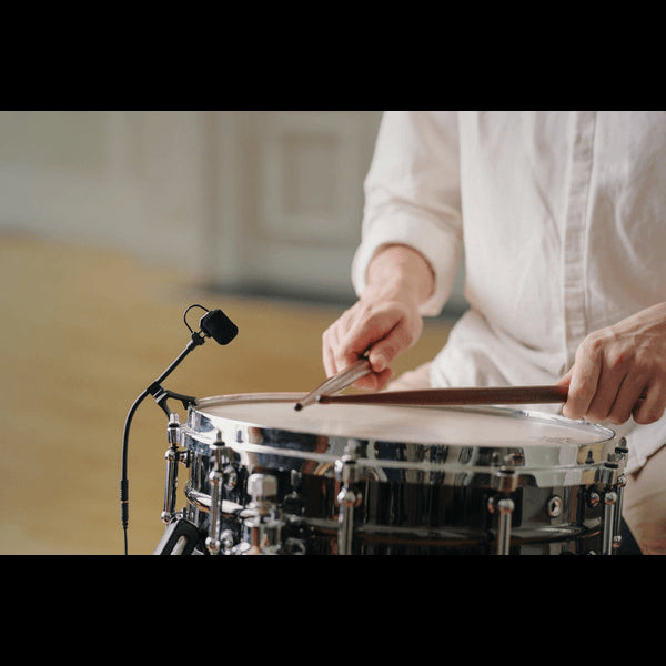 Neumann MC 7 miniature clip microphone system designed for snare drums, showcasing the drum rim clip.