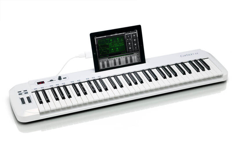 Samson Carbon 61 USB MIDI Keyboard Controller with 61 keys, assignable controls, and an iPad slot, shown from an angle on a white background.